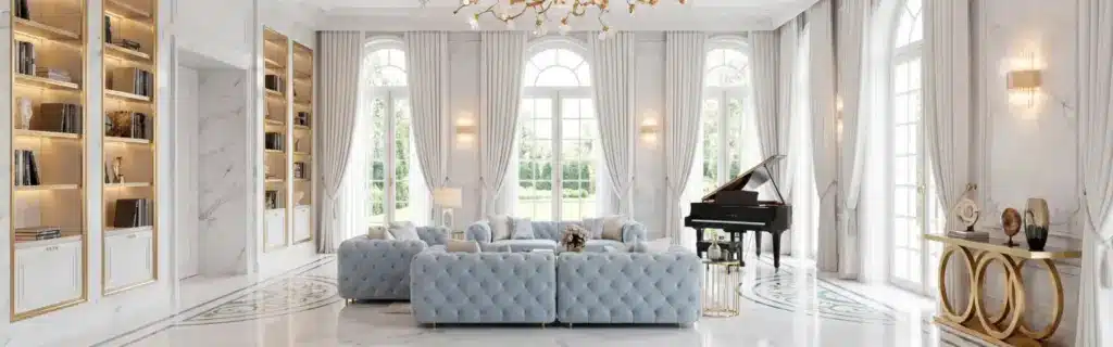 Opulent French interior design style salon with blue tufted sofas, gold chandelier, marble medallion floor, and a grand piano.